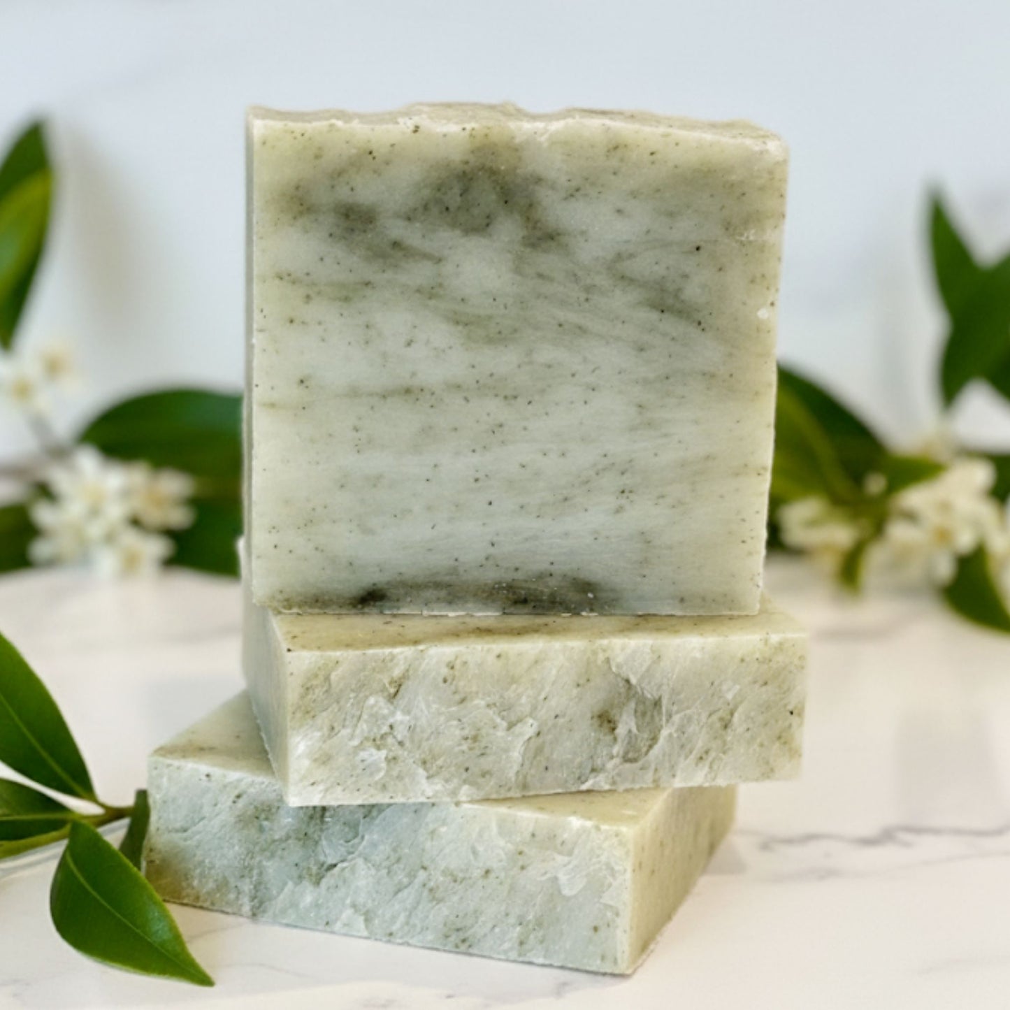 Handcrafted soap bar with natural green and creamy white swirls, inspired by the crisp, herbaceous aroma of pure tea tree oil. Purifying, earthy, and refreshing.