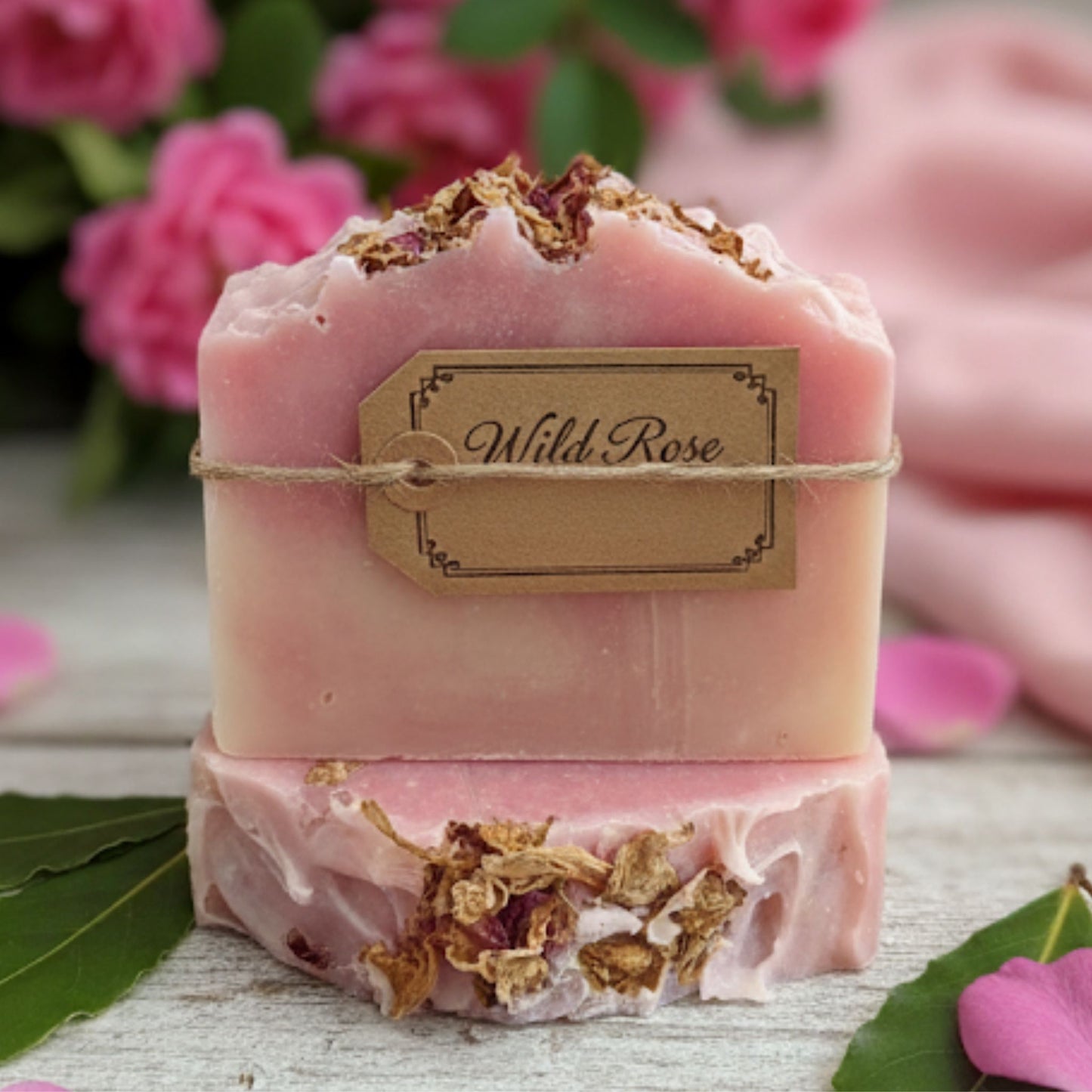 Handcrafted soap bar with delicate swirls of rose pink, cream, and blush tones, capturing the essence of a blooming wild rose garden. Feminine, floral, and naturally elegant.